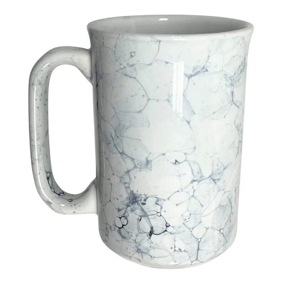 Marble ceramic coffee mug styled on a café table ready for daily service